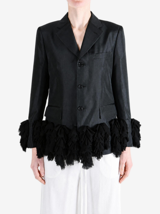Black jacket worn by a person, showing the jacket fit