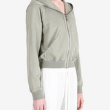 Green hoodie worn by a person, showing the hoodie fit