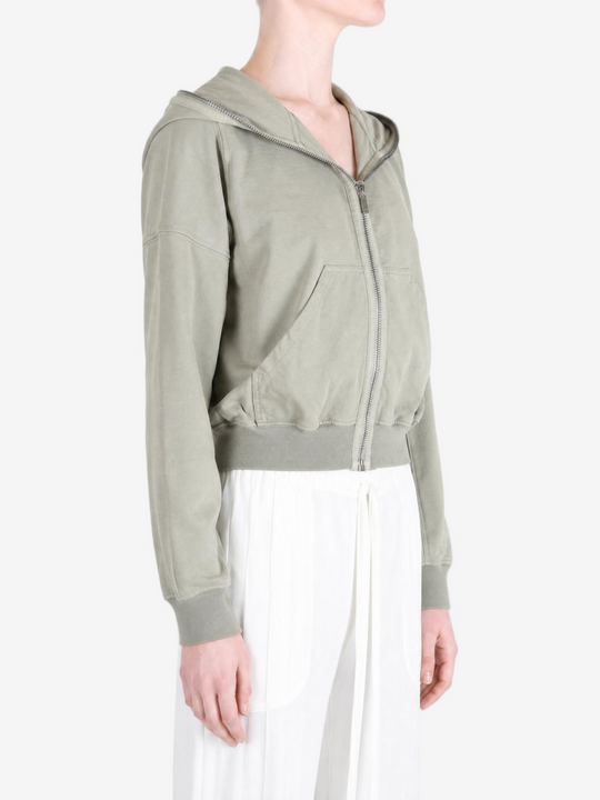 Green hoodie worn by a person, showing the hoodie fit
