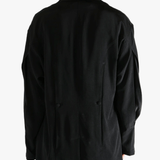 Black jacket worn by a person, showing the  jacket's fit