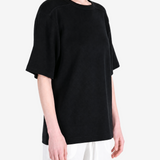 Black t-shirt worn by a person, showing the t-shirt fit
