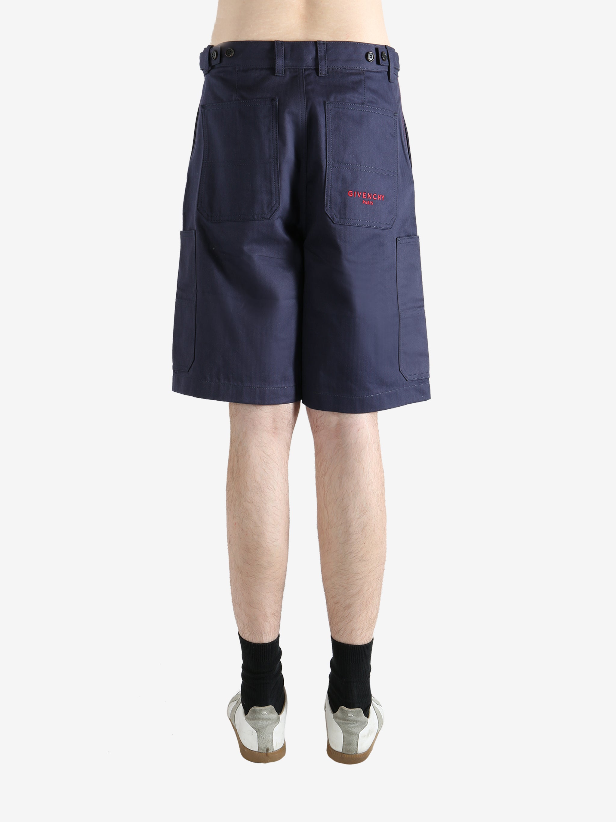 Navy shorts worn by a person, showing the shorts fit
