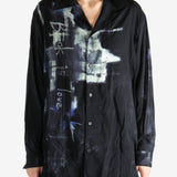 Black shirt worn by a person, showing the shirt's fit