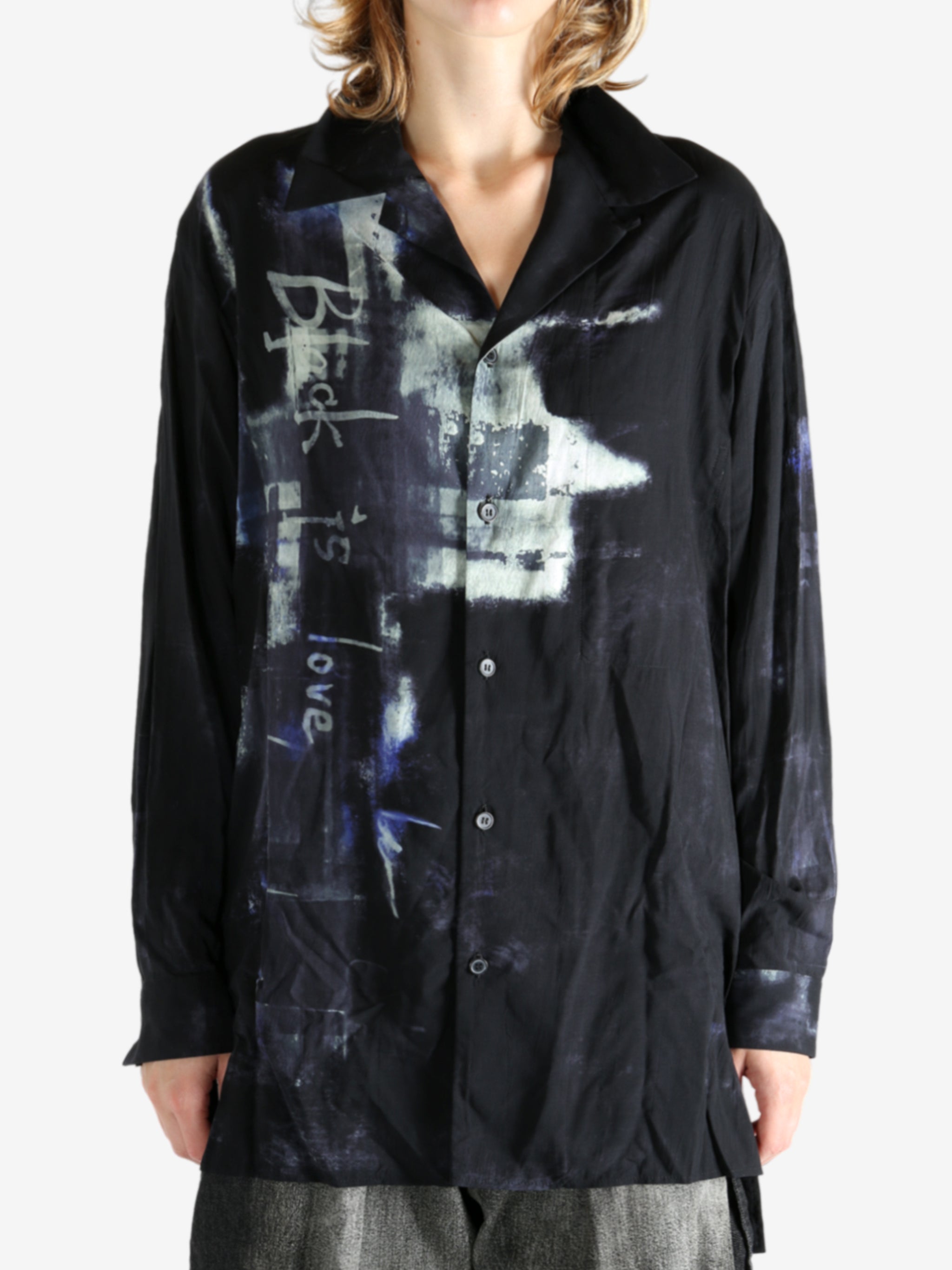 Black shirt worn by a person, showing the shirt's fit