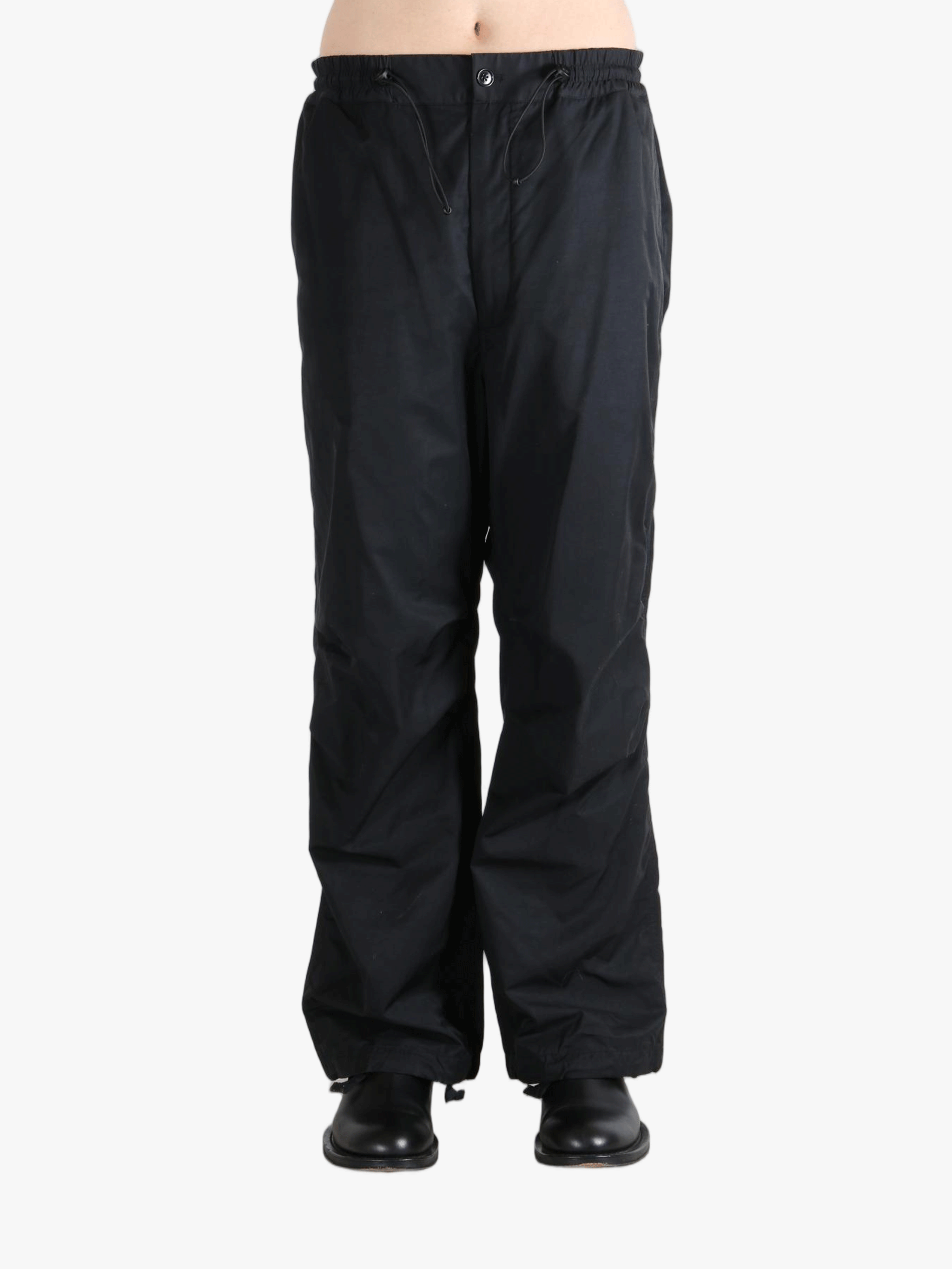 Black pants  worn by a person, showing the pants fit