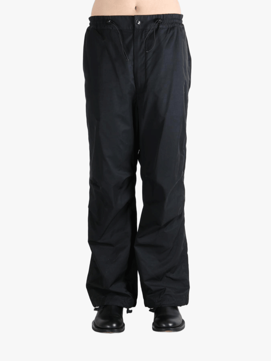 Black pants  worn by a person, showing the pants fit