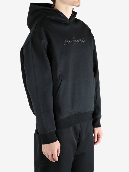 Black hoodie worn by a person, showing the hoodie's fit