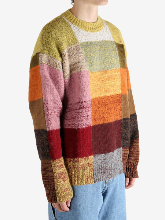 Yellow sweater worn by a person, showing the sweater's fit