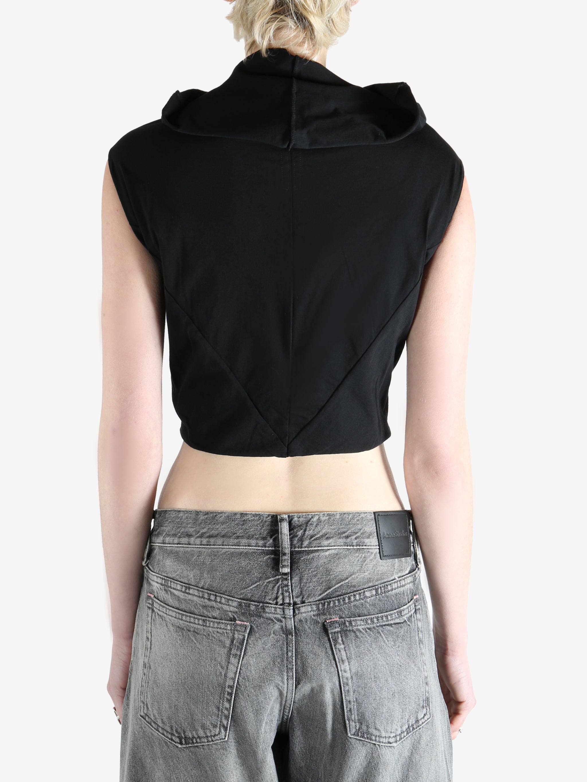 black sleeveless top worn by a person, showing the top fit