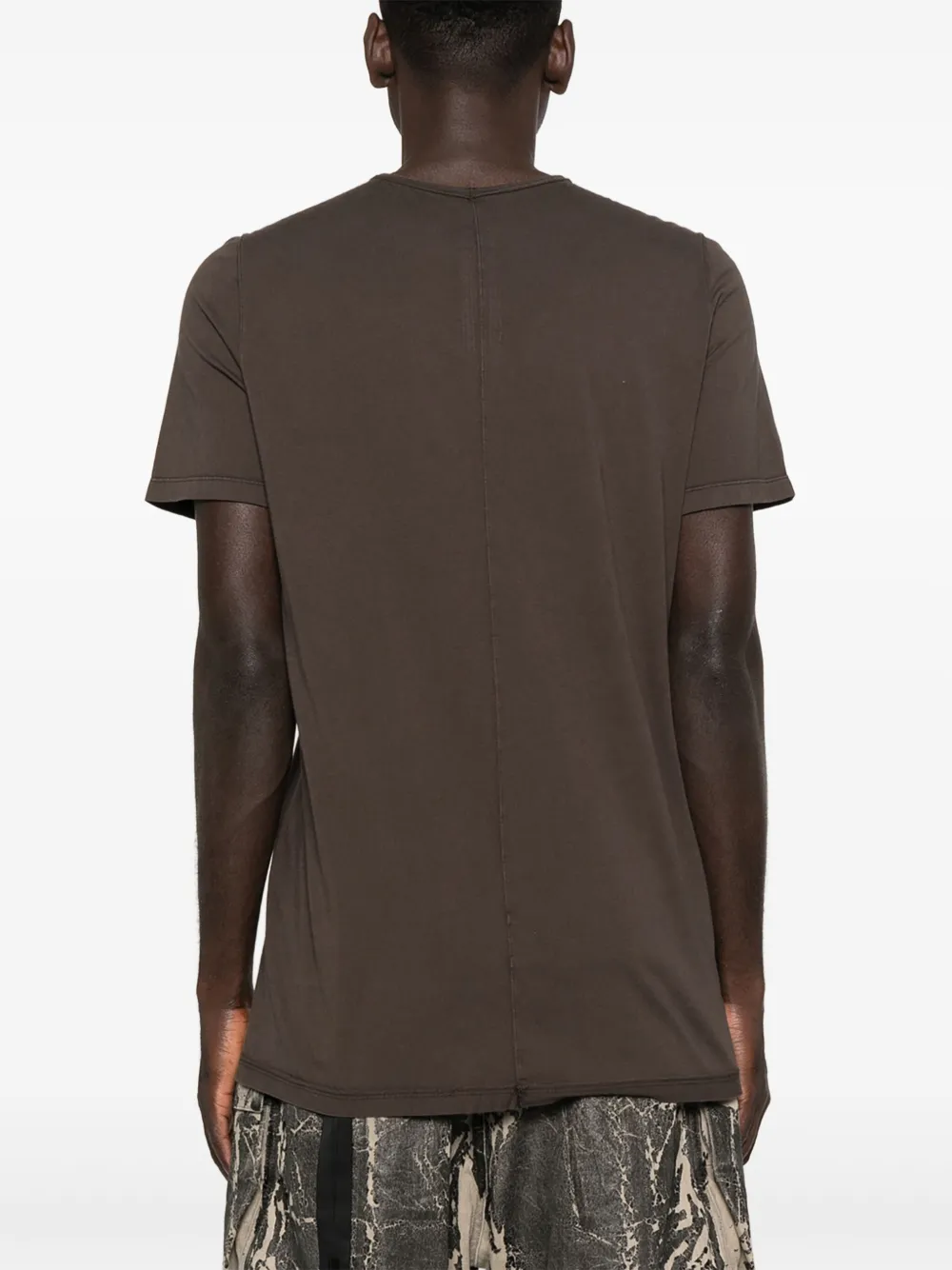 Brown t-shirt worn by a person, showing the shirt's fit