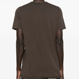 Brown t-shirt worn by a person, showing the shirt's fit