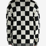 Black cardigan worn by a person, showing the cardigan’s fit