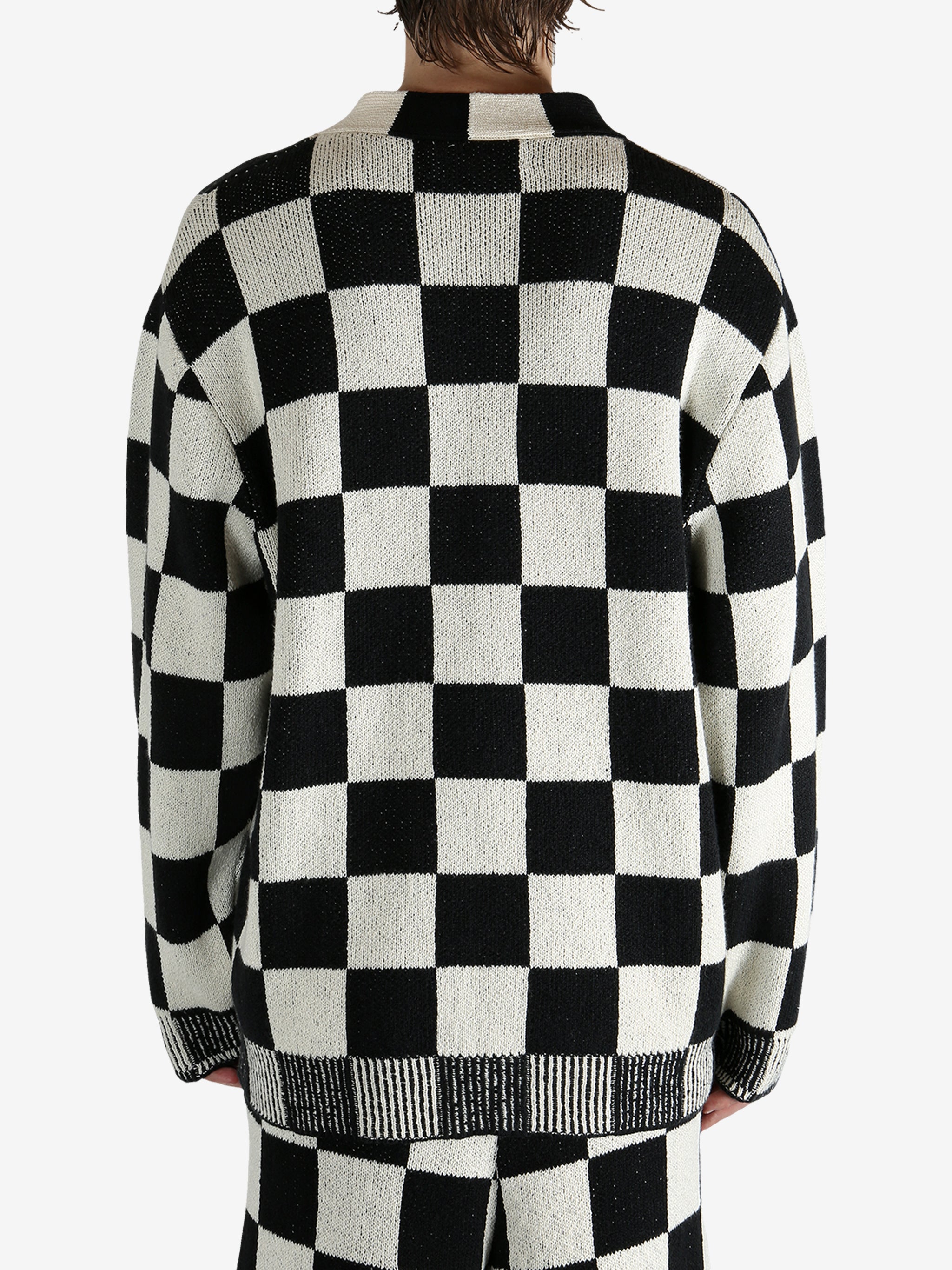 Black cardigan worn by a person, showing the cardigan’s fit