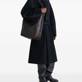 brown bag carried by a person, showing the size of the bag