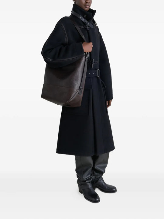 brown bag carried by a person, showing the size of the bag