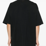 black t-shirt worn by a person, showing the t-shirt fit