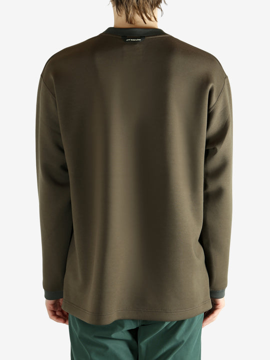 Brown pullover worn by a person, showing the pullover 's fit