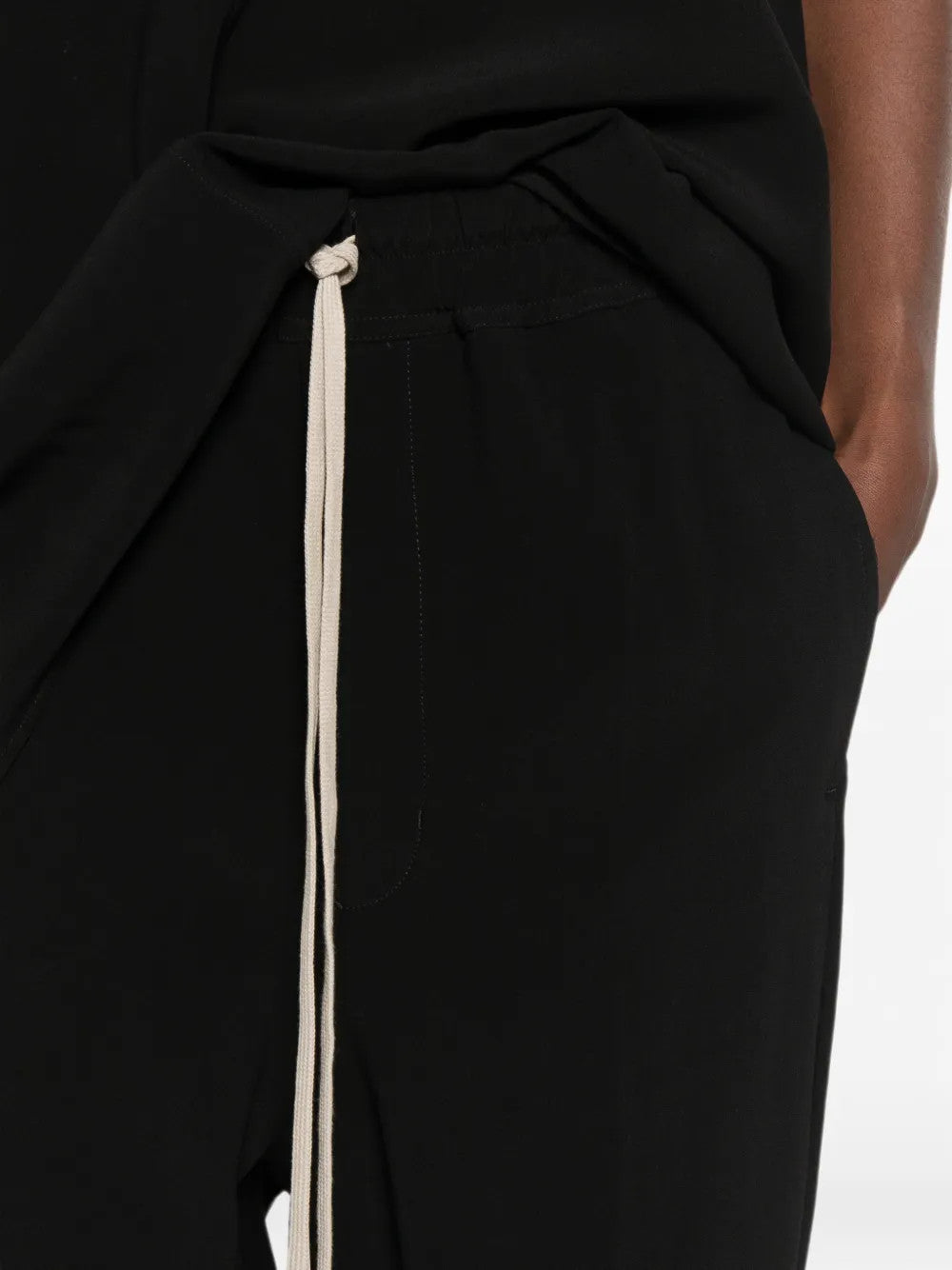 Black pants worn by a person, showing the pants fit