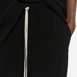 Black pants worn by a person, showing the pants fit