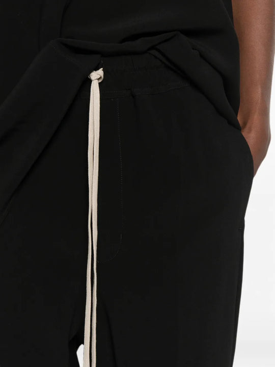 Black pants worn by a person, showing the pants fit