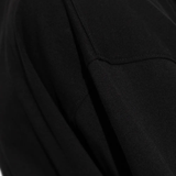 close up of black t-shirts, showing texture of the cotton fabric