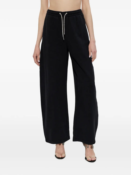 Black pants worn by a person, showing the  pants' fit