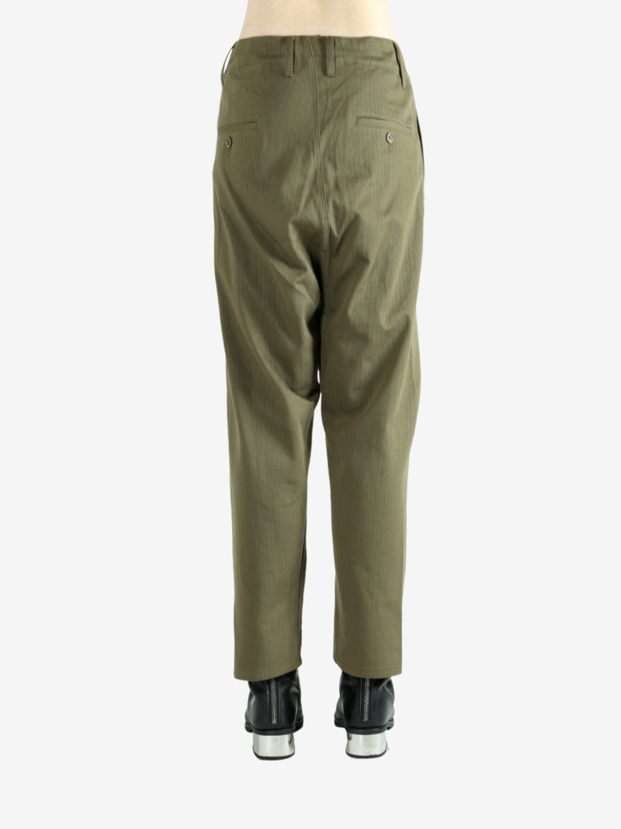 Green pants worn by a person, showing the pants's fit