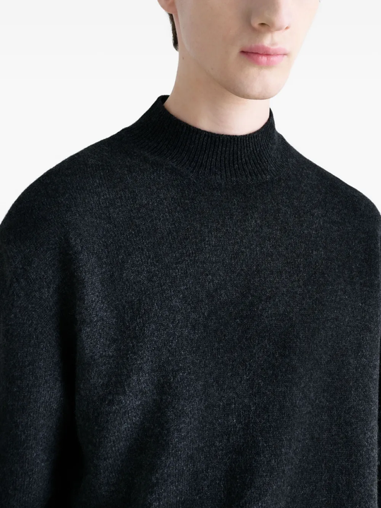 Close up of black knitwear, showing texture of the wool fabric
