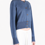Blue knitwear worn by a person, showing the knitwear fit