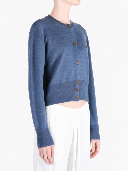 Blue knitwear worn by a person, showing the knitwear fit