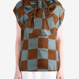Brown top worn by a person, showing the top fit