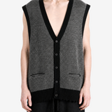 Grey knitwear worn by a person, showing the knitwear fit