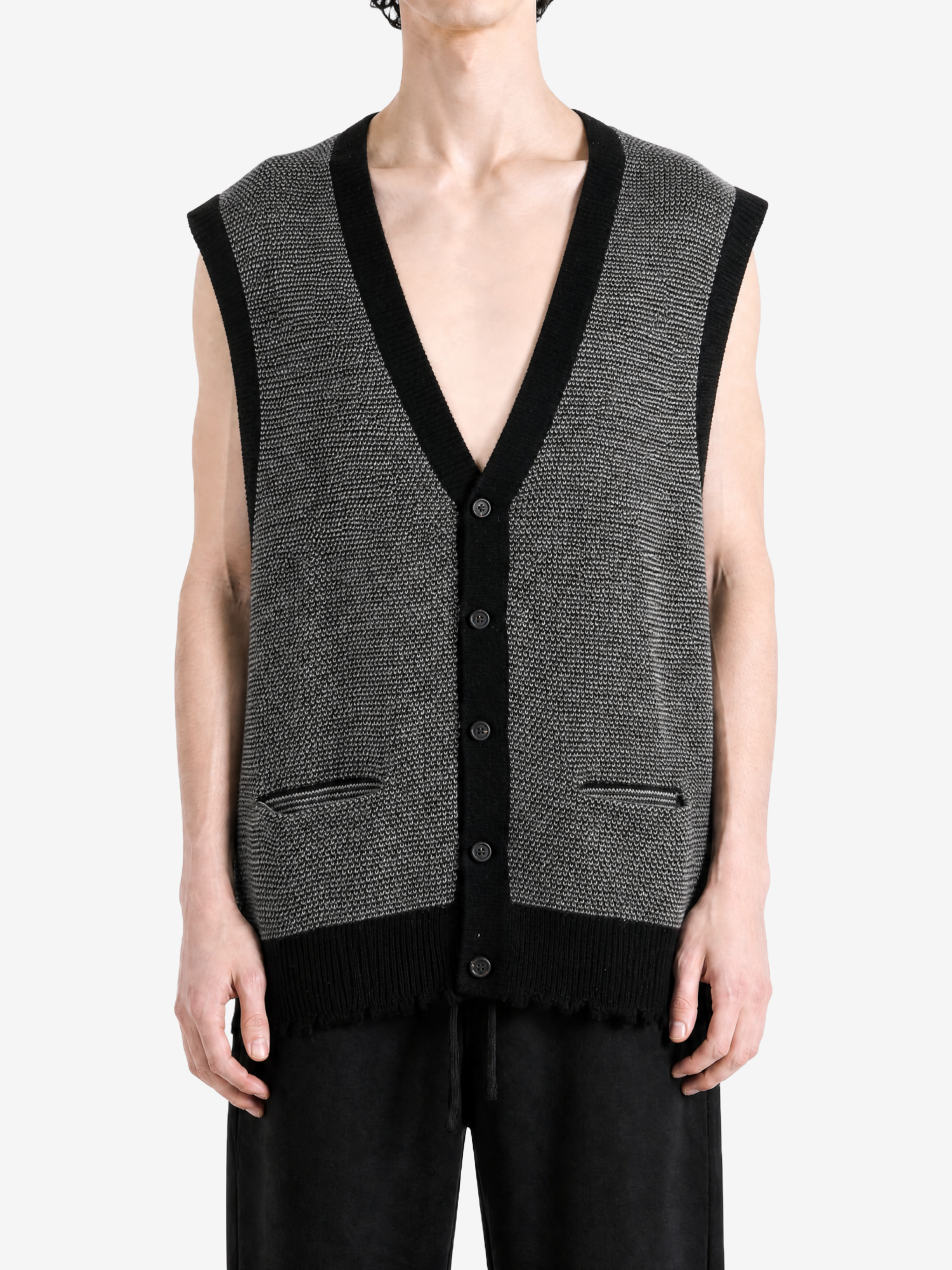 Grey knitwear worn by a person, showing the knitwear fit