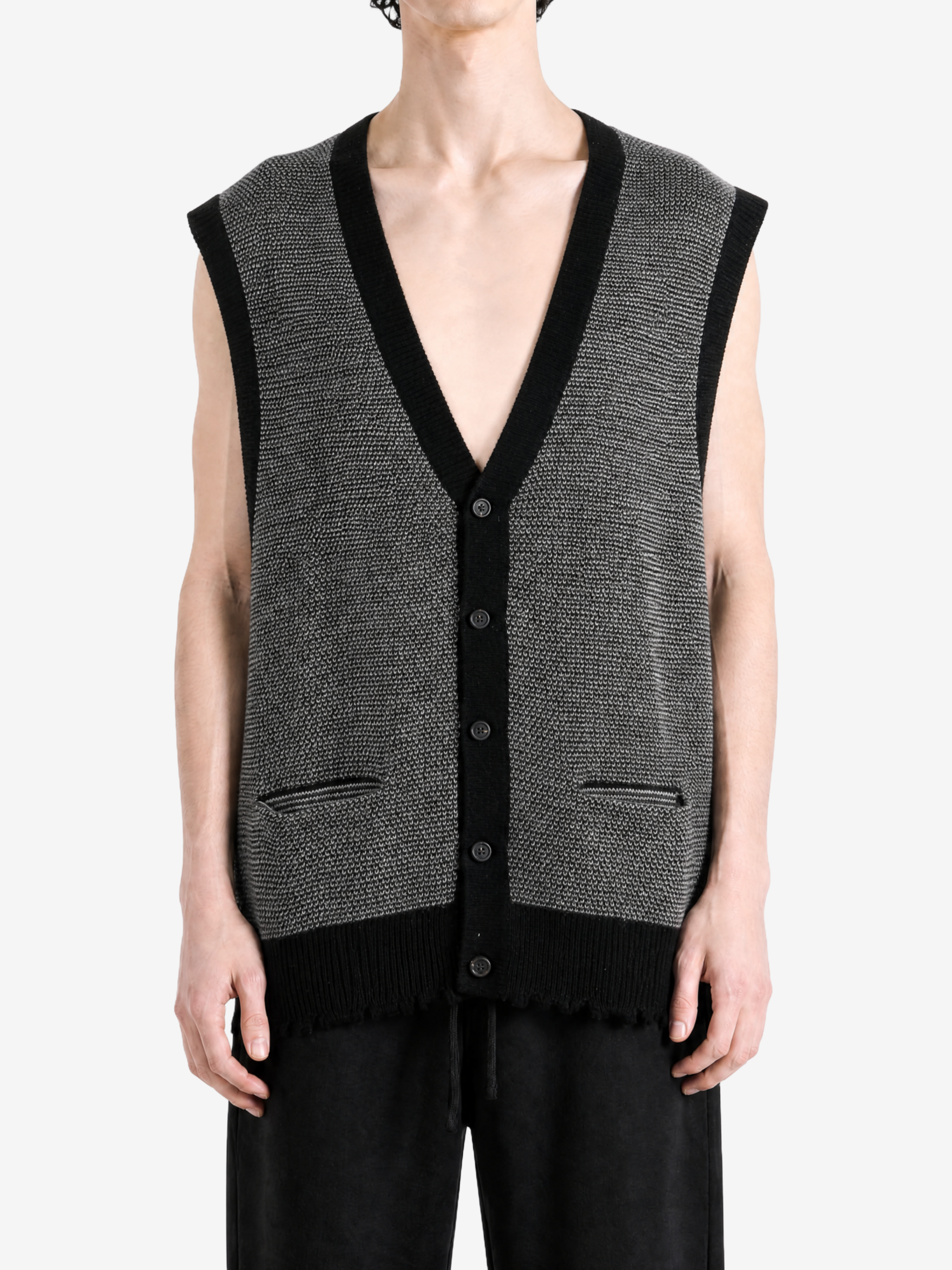 Grey knitwear worn by a person, showing the knitwear fit