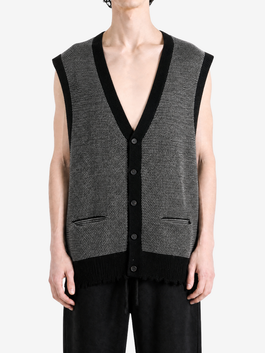 Grey knitwear worn by a person, showing the knitwear fit