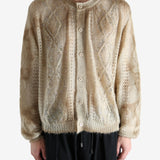 Tan knitwear worn by a person, showing the knitwear's fit