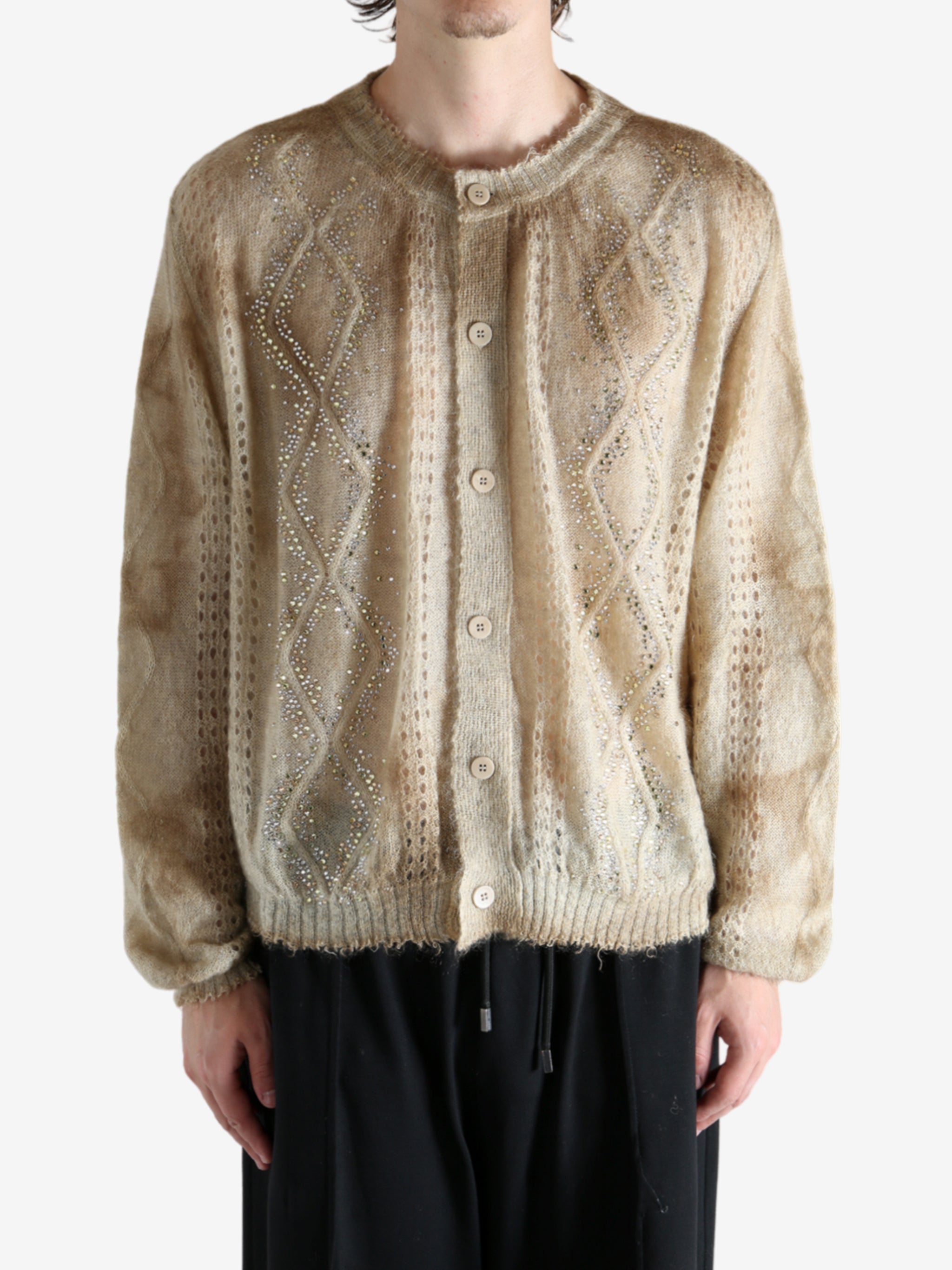 Tan knitwear worn by a person, showing the knitwear's fit