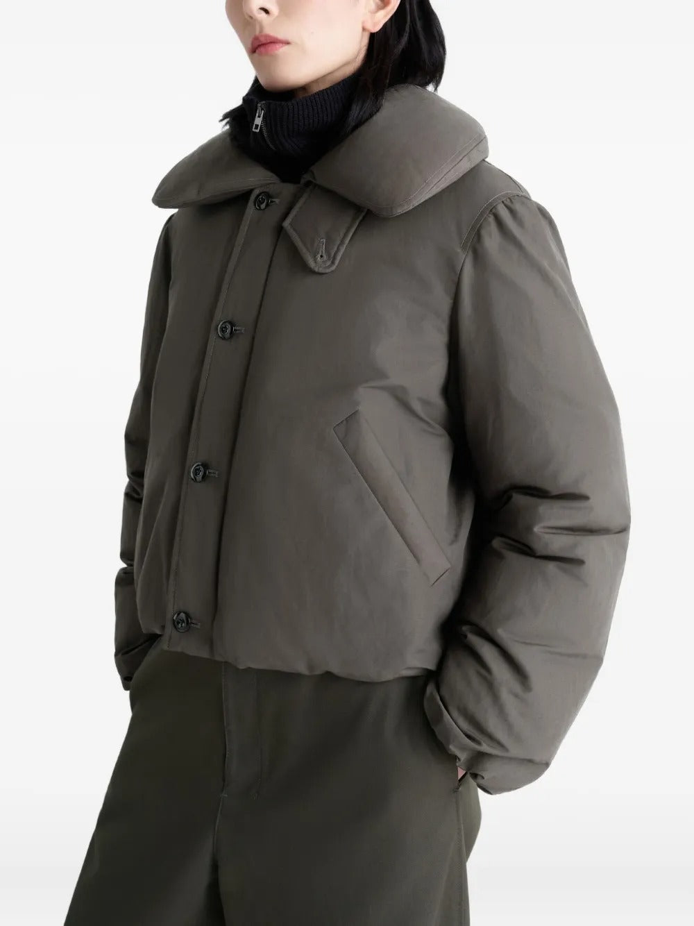 Grey coat worn by a person, showing the coat's fit