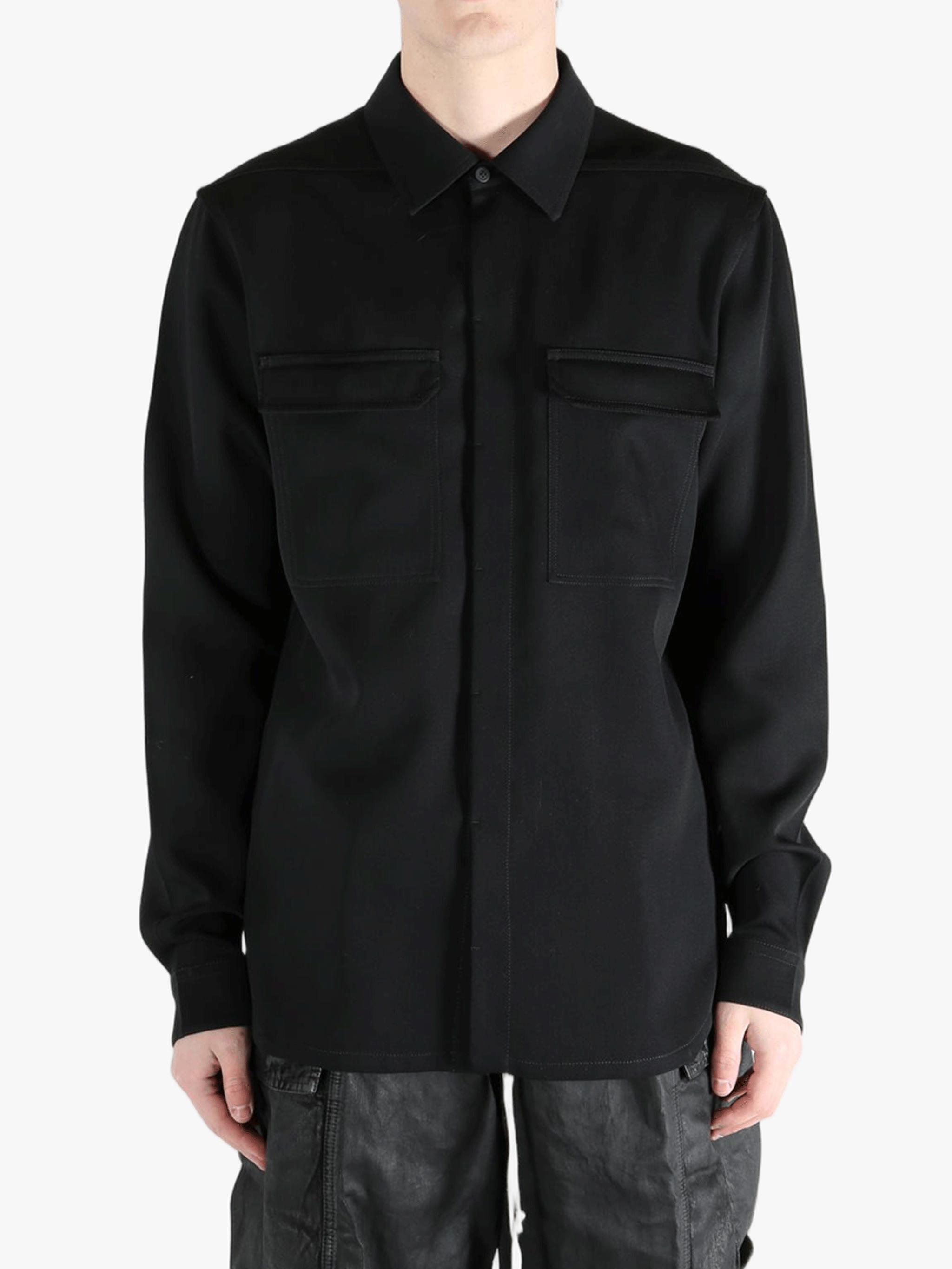 Black shirts worn by a person, showing the shirts fit