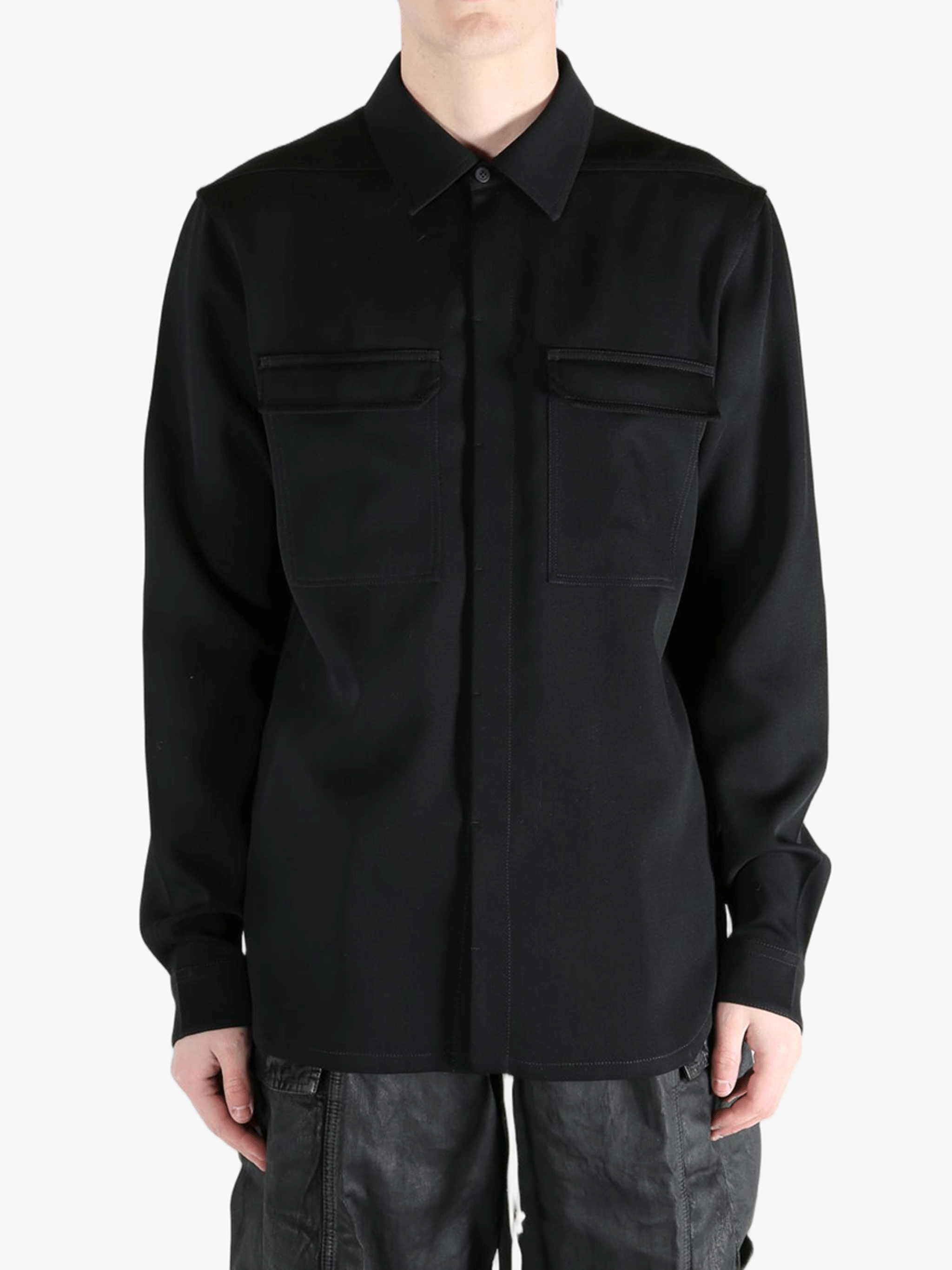 Black shirts worn by a person, showing the shirts fit