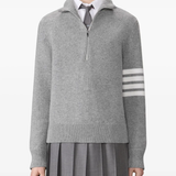 grey knitwear worn by a person, showing the knitwear fit