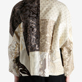 Tan coat worn by a person, showing the coat fit