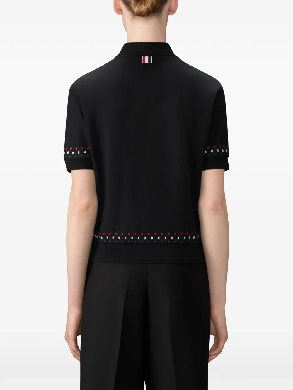 Black t-shirt worn by a person, showing t-shirt's fit