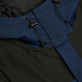 Close up of Navy jacket, showing texture of the 100% recycled nylon made fabric