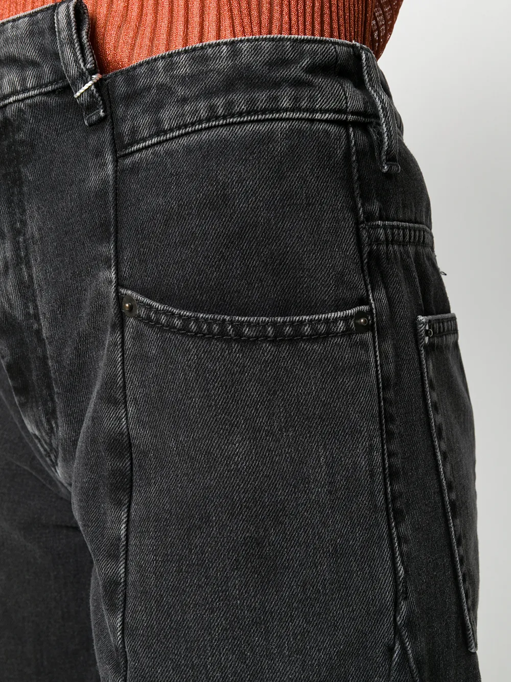 Close up of black pants, showing texture of the Denim fabric