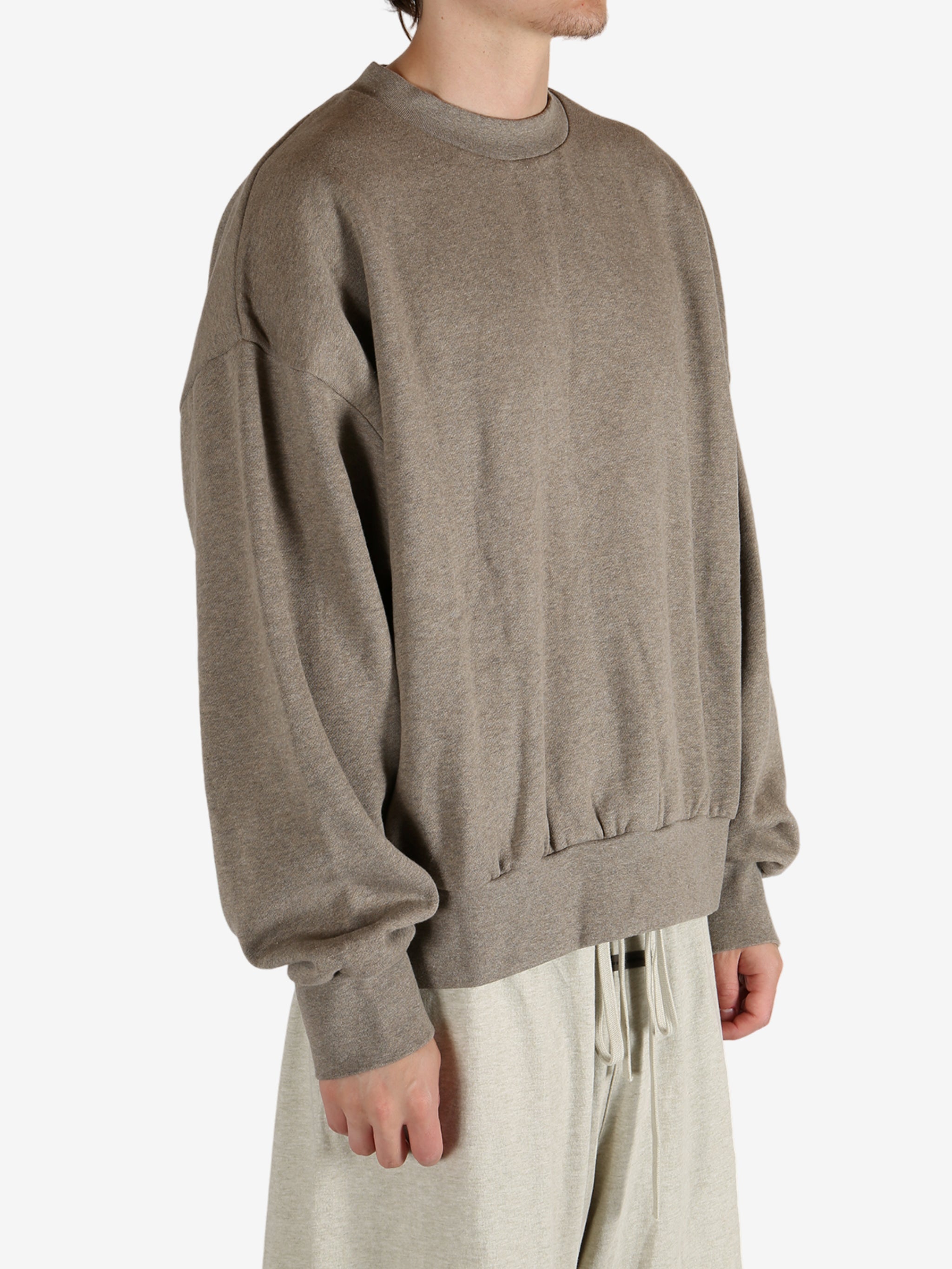 Grey tops worn by a person, showing the tops fit