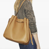 Tan bag worn by a person, showing the bag fit