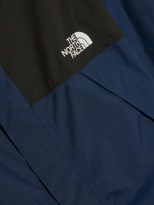 Close up of Navy jacket, showing texture of the 100% recycled nylon made fabric