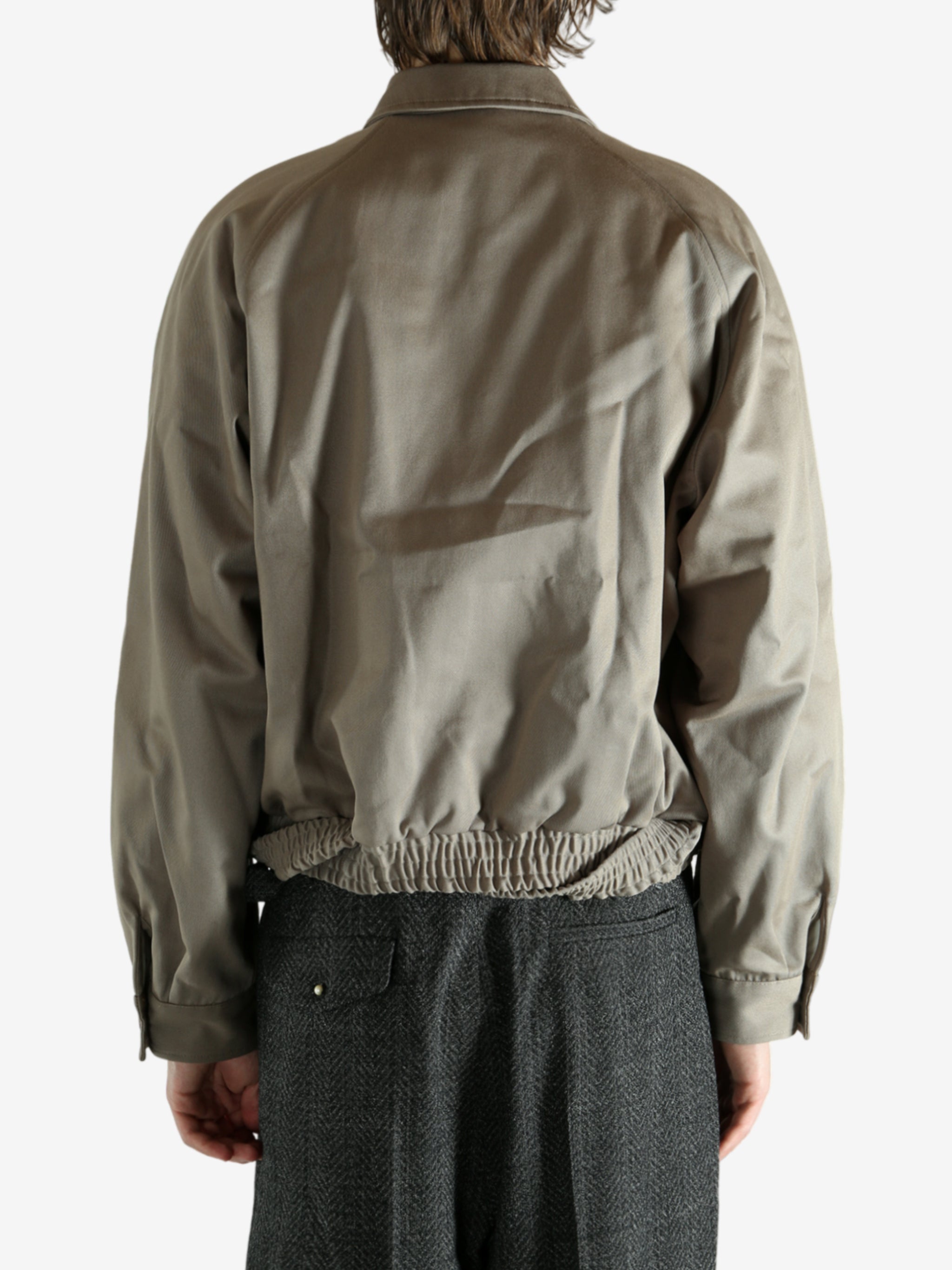 Tan jacket worn by a person, showing the jacket's fit
