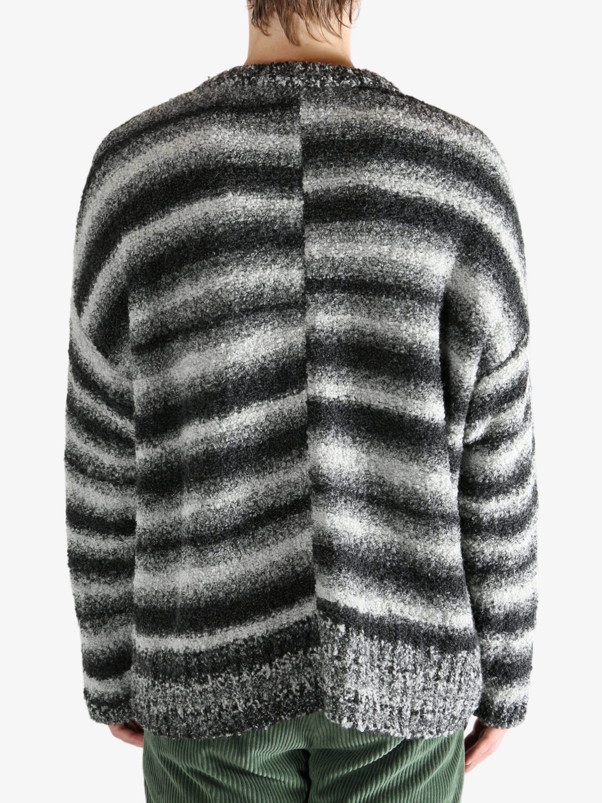 Black knitwear worn by a person, showing the knitwear's fit